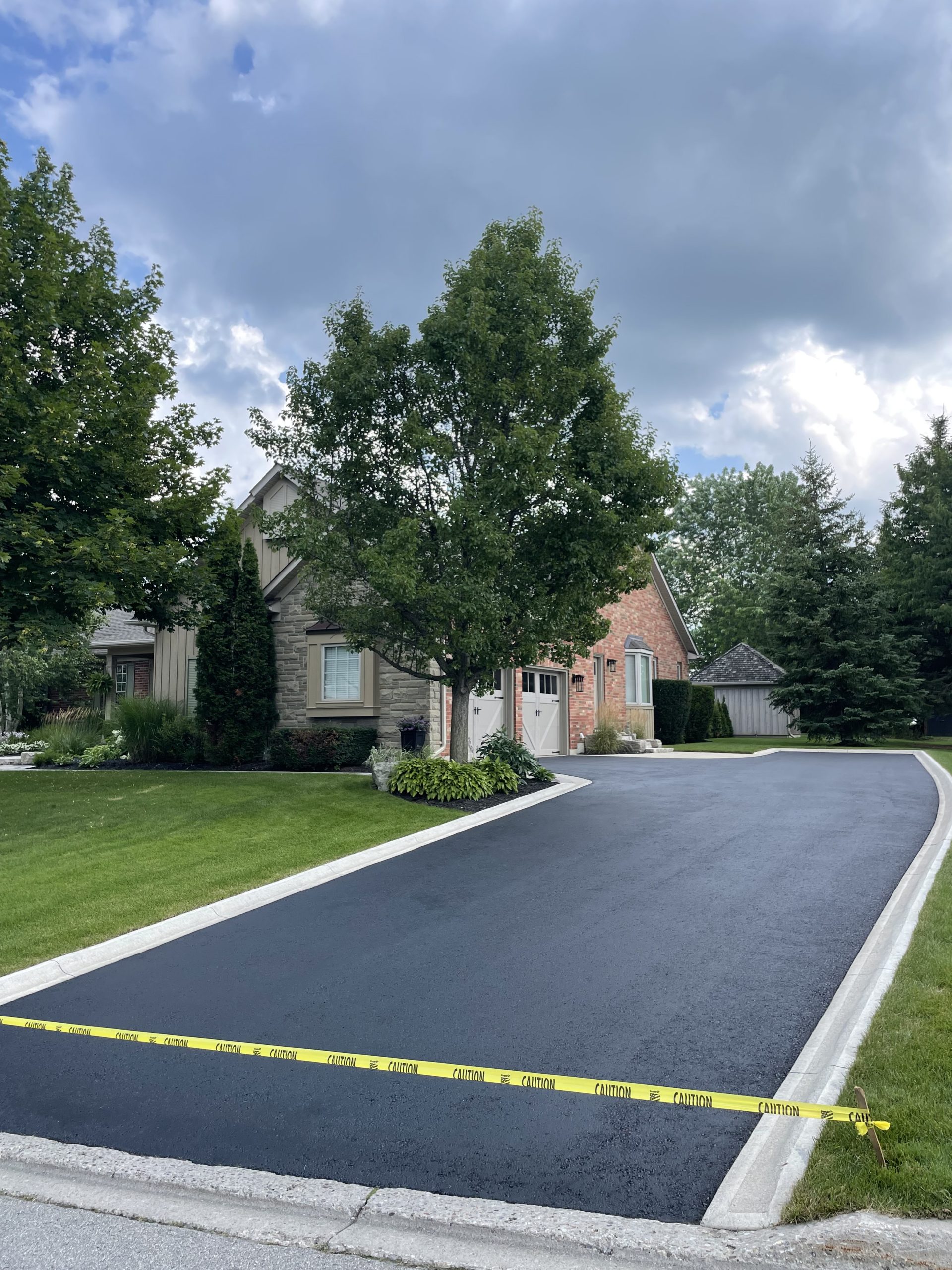 Freshly sealed asphalt driveway near Hamilton, Ontario — completed to perfection by SealStar Canada, proudly serving Oakville, Burlington, and surrounding areas.